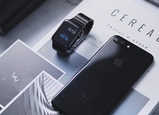 apple iphone and apple watch placed on some business documents